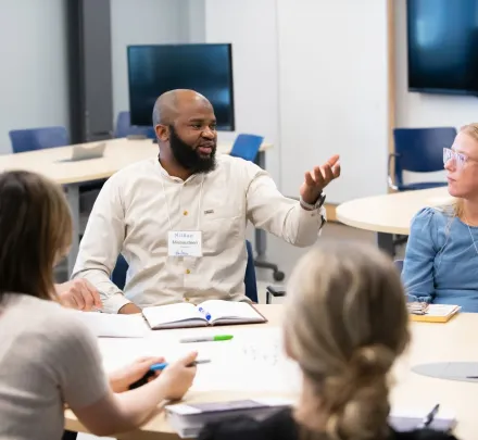 a small group speaking at a table