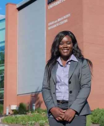 student in front of duffy research centre