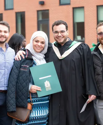 family and friends congratulate a UPEI graduate