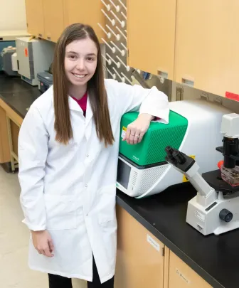 female researcher and microscope