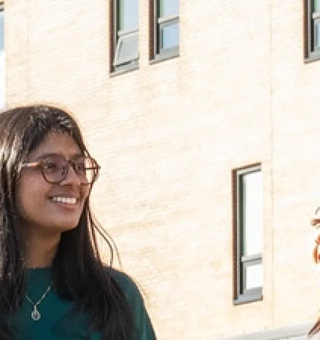 students walking in front of the UPEI performing arts centre and residence