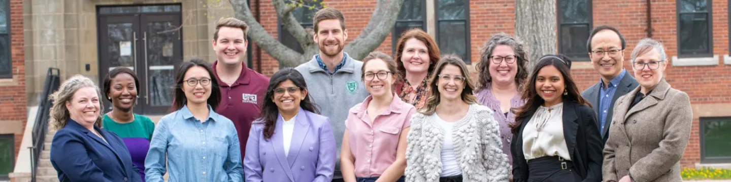 13 members of UPEI's international office staff standing outside Dalton Hall