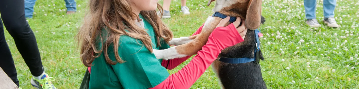 A vet camp participant plays with a dog