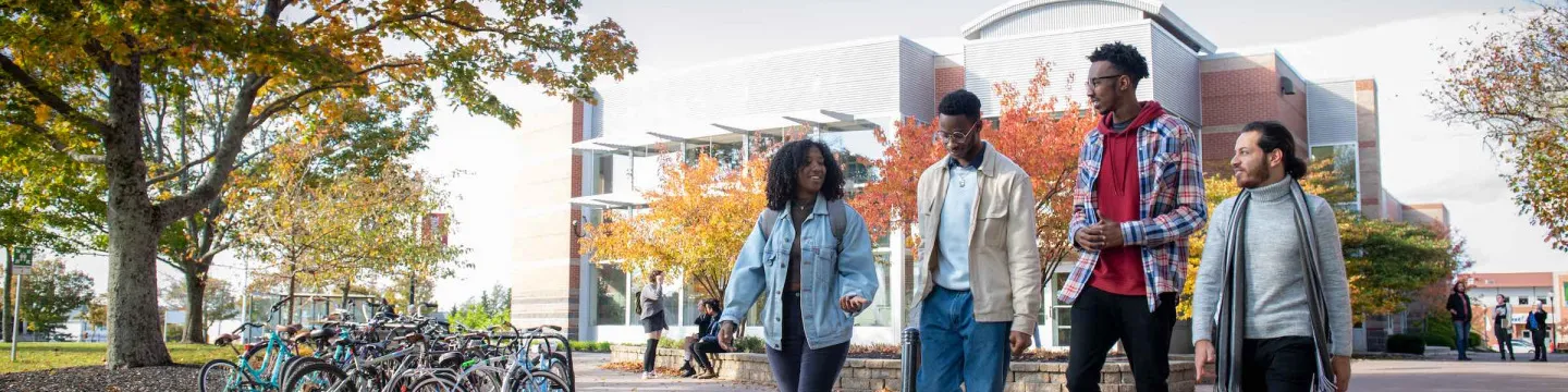 four students in the UPEI quad in fall