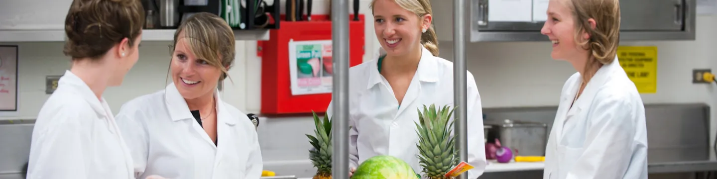 four dietitians preparing a fruit tray