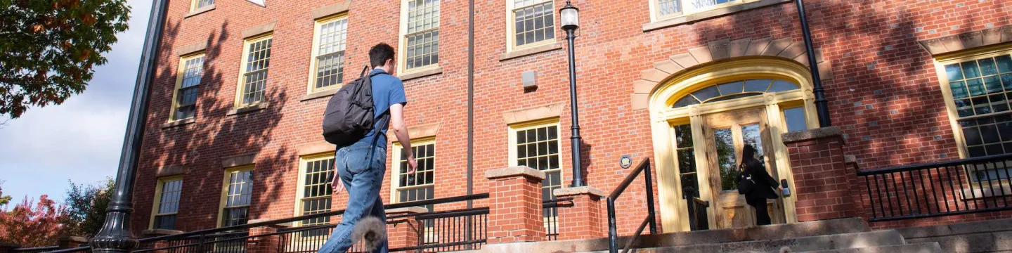 a student walking into SDU Main Building