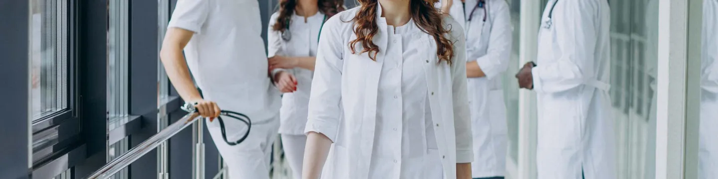 a group of medical professionals talking in a hallway