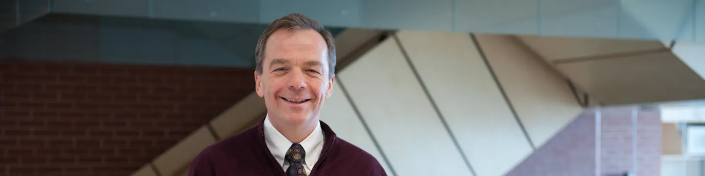 upei professor and researcher bill montelpare standing in health sciences building stairwell in background