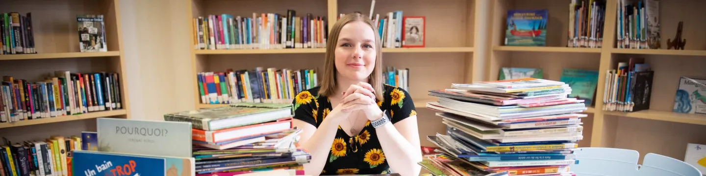 UPEI education student Madi in the Education Resource Centre