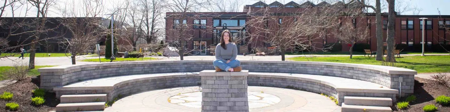 UPEI student Annika Masters in the stone theatre outside the Chaplaincy Centre