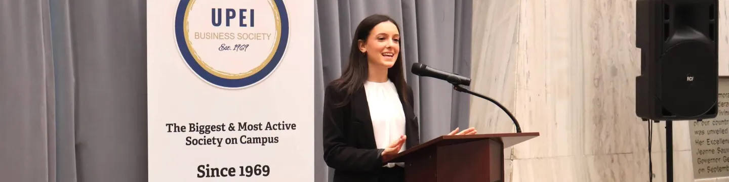 Charlize Sahely speaking at a podium