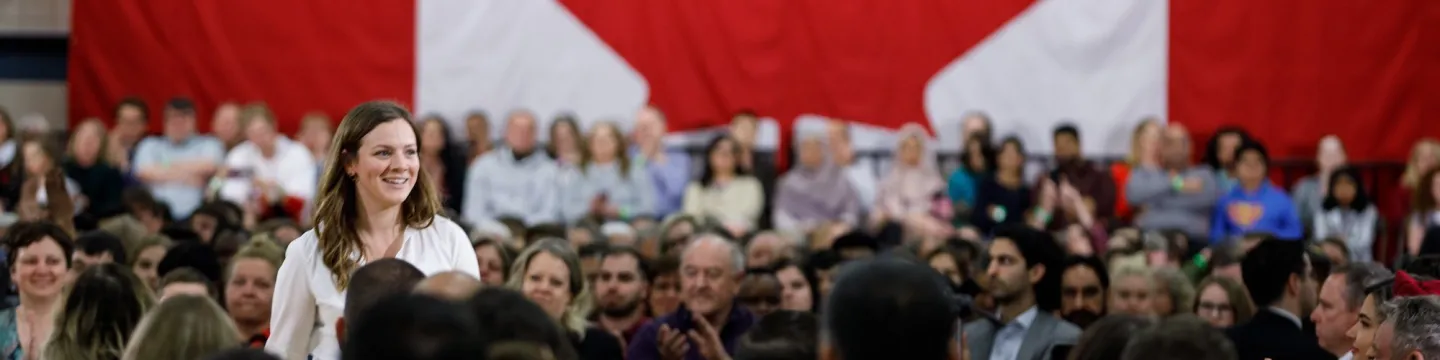 Kate VanGerven at a ministerial announcement with a large crowd