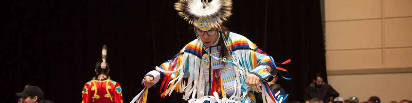 a dancer in traditional Indigenous dress
