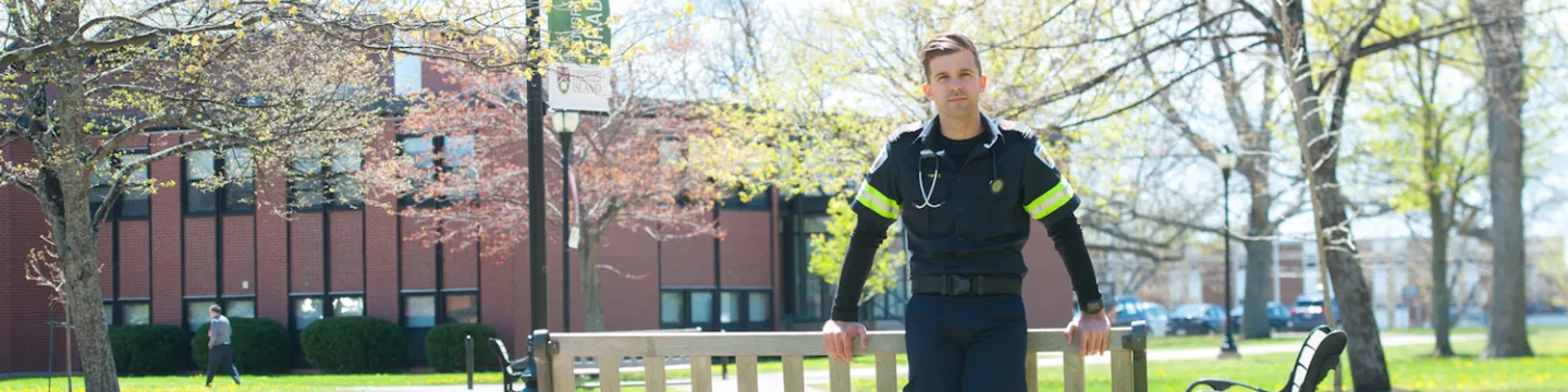 male paramedic standing in the UPEI quad