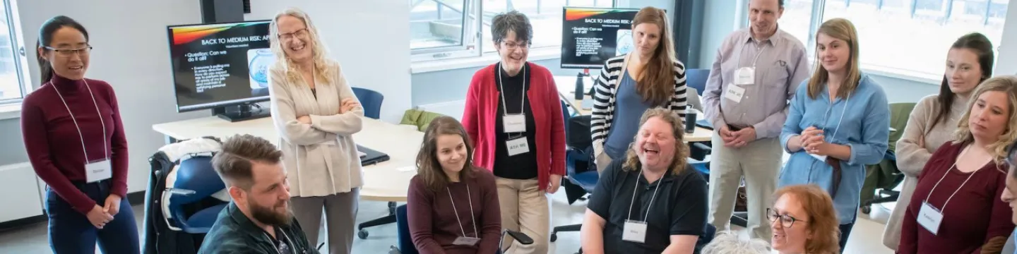 a group of UPEI instructors laughing during a workshop