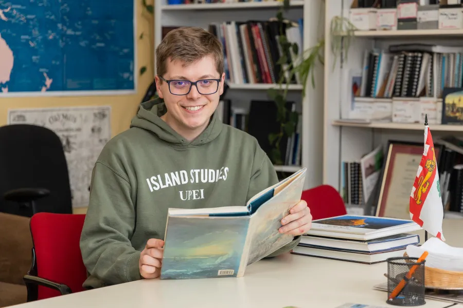 UPEI Master of Arts in Island Studies student Jack Weeks reading a book