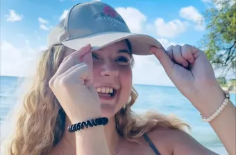 a female student with the ocean behind