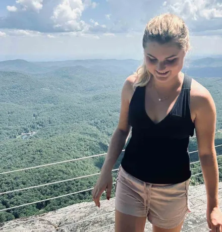 a female student with a valley behind her