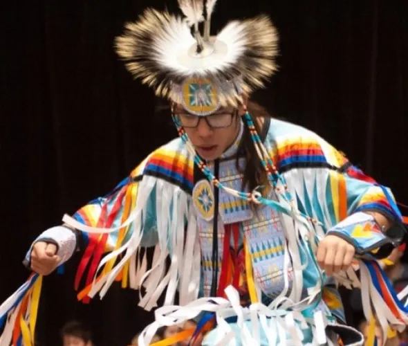 a dancer in traditional Indigenous dress
