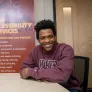 UPEI student Antwaun Rolle seated at boardroom table 